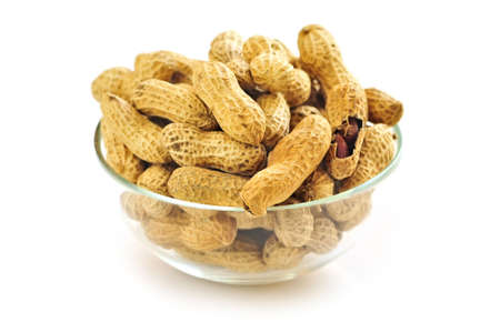 Closeup on bowl of peanuts with shells