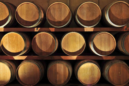 Stacked oak wine barrels in winery cellar