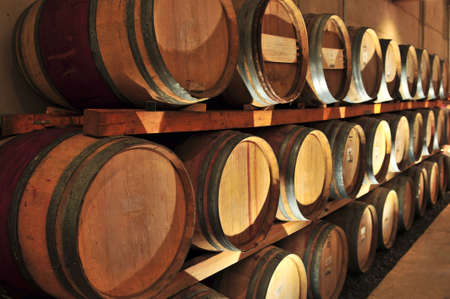 Stacked oak wine barrels in winery cellar
