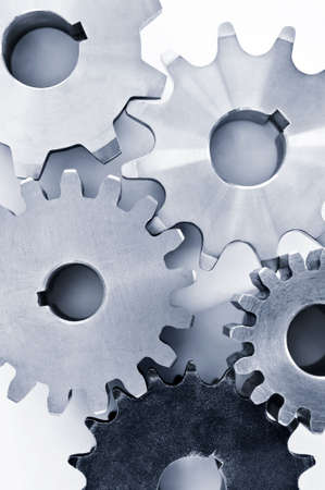 Interlocking industrial metal gears isolated on white