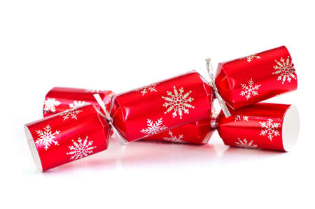 Two red Christmas crackers isolated on whiteの写真素材