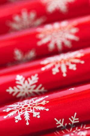 Closeup of many red Christmas crackers in a rowの写真素材