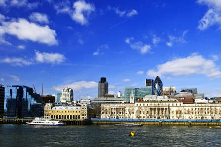 London skyline view from Thames river against blue sky