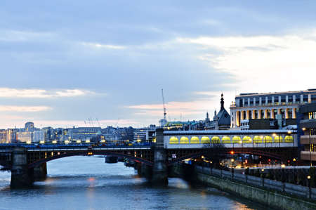 View of bridge and cityscape on Thames river in London at nightの写真素材