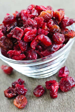 Dried cranberries spilling out of glass bowl Dried cranberries spilling out of glass bowl