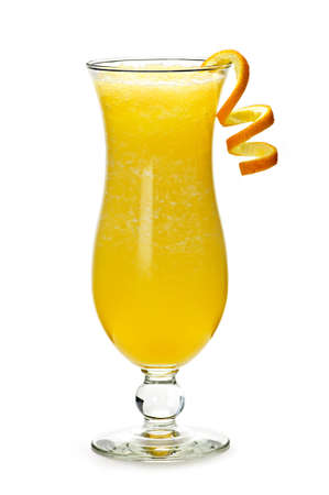 Glass of orange drink in hurricane cocktail glassの写真素材