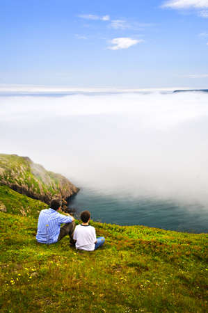 Father and son looking at foggy ocean on Signal Hill, Newfoundland Father and son looking at foggy ocean on Signal Hill, Newfoundland