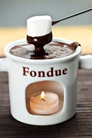 Marshmallow dipped in delicious melted chocolate fondueの写真素材