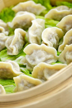 Closeup of bamboo steamer with cooked dumplingsの写真素材