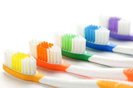 Close up of multicolored toothbrushes on white backgroundの写真素材
