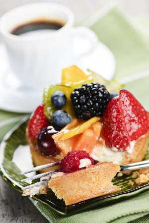 Fresh mixed berry tart served with coffee for dessertの写真素材