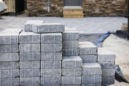 Stacks of interlocking stones for installing driveway landscapingの写真素材