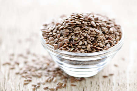 Bowl full of brown flax seed or linseedの写真素材