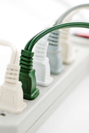 Many plugs plugged into electric power barの写真素材