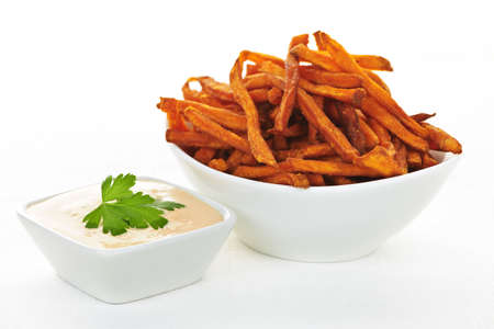 Bowl of sweet potato or yam fries with dipping sauceの写真素材 [40007745760