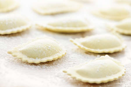 Uncooked ravioli pasta prepared and ready for cookingの写真素材