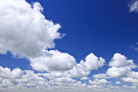 Background of blue sky with white cumulus clouds