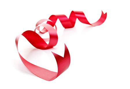 Curled red holiday ribbon strip isolated on white backgroundの写真素材