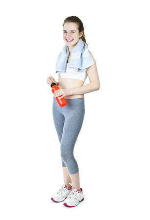 Happy fit young woman after workout with towel and water bottleの写真素材