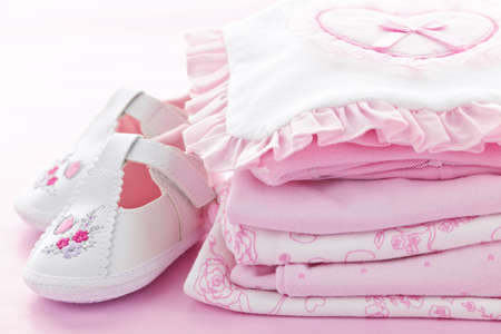 Pink infant girl clothing and shoes for baby showerの写真素材