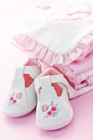 Pink infant girl clothing and shoes for baby showerの写真素材