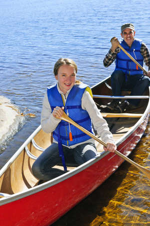Father and daughter canoeing on Lake of Two Rivers, Ontario, Canada