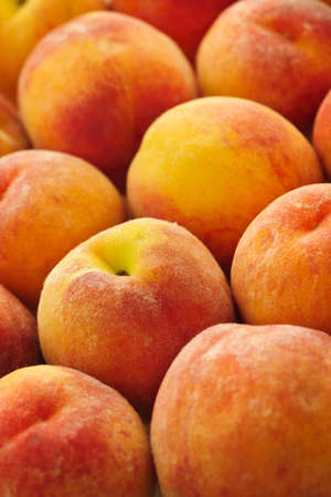 Ripe fresh peaches as background close upの写真素材