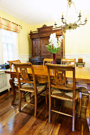 Dining room interior with antique wooden table and chairs in houseの写真素材