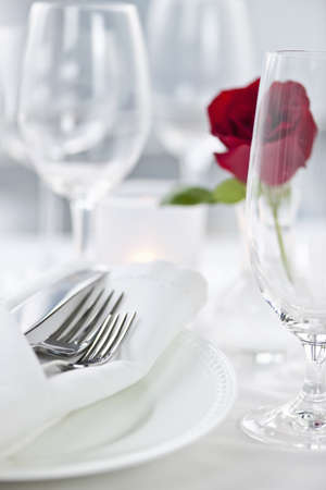 Romantic table setting with rose plates and cutleryの写真素材
