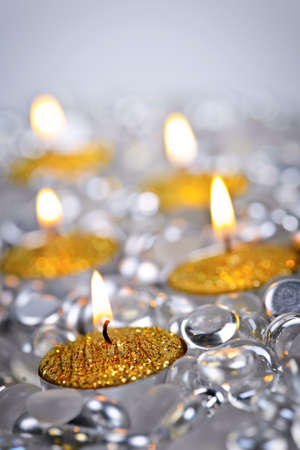 Burning golden decorative Christmas candles with glass beadsの写真素材