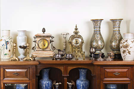Various antique clocks vases and candlesticks on displayの写真素材