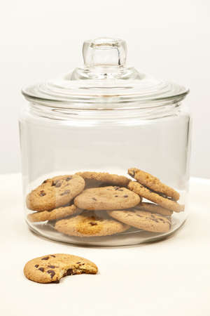 Glass cookie jar with chocolate chip cookiesの写真素材
