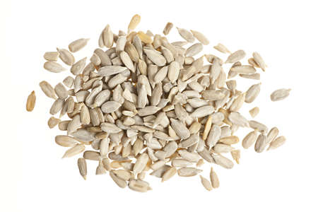 Heap of raw shelled sunflower seeds isolated on white background from aboveの写真素材