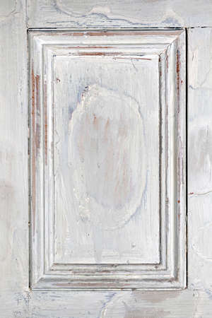 Old distressed wood door panel with peeling paint as framed backgroundの写真素材