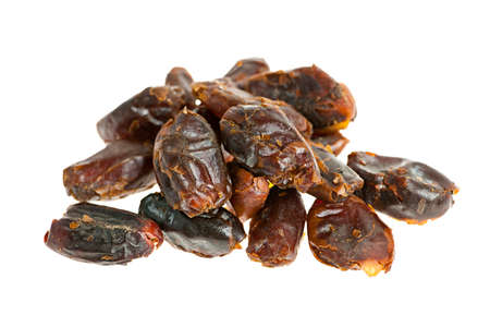 Closeup on pile of dried medjool dates isolated over white background