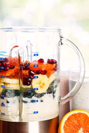Closeup of healthy smoothie ingredients in blender with fresh fruitの写真素材