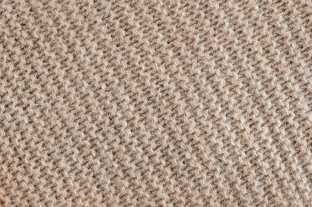 Knit texture of undyed brown alpaca wool knitted fabric with diagonal garter stitch pattern as backgroundの写真素材