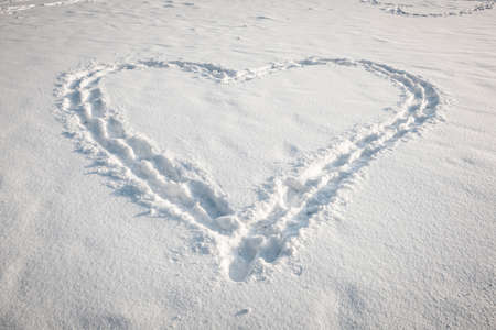 Romantic heart shape made in fresh snowの写真素材