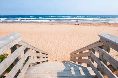Wooden steps leading to Atlantic beach in Prince Edward Island, Canadaの写真素材