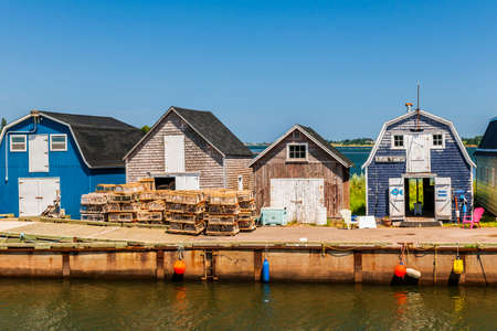 CAVENDISH, PRINCE EDWARD ISLAND, CANADA - JULY 15 2013: Fishing dock with buildings and lobster traps shown on July 15, 2013 in Cavendish, Prince Edward Island, Canadaのeditorial素材