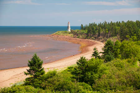 Atlantic beach coast with Cape Jourimain lighthouse, New Brunswick, Canadaの写真素材