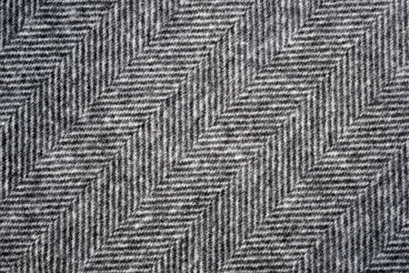 Herringbone tweed background with closeup on wool fabric textureの写真素材
