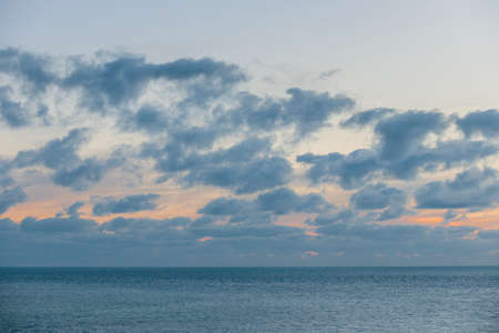 Turquoise water of calm ocean and cloudy sky after sunset at Florida Keysの写真素材