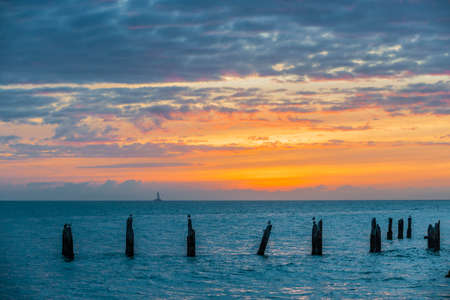 Sunset over Gulf of Mexico turquoise water viewed from the southernmost point in Key West, Florida.の写真素材