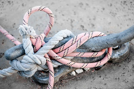 Nautical ropes tied around horn cleat on dock, close up.  Key West harbor, Florida.の写真素材