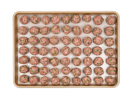 Cooking tray with rows of prepared homemade meatballs, overhead view isolated on white backgroundの写真素材