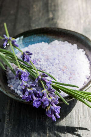 Lavender bath salts herbal body care product in dish with fresh flowers close upの写真素材