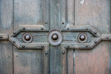 Fragment of an old wooden door of Saint Sernin Basilica in Toulouse, France.