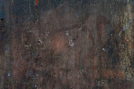 Abstract background of old painted plastered brown wall with layers peeling paint and distressed plaster texture.の写真素材