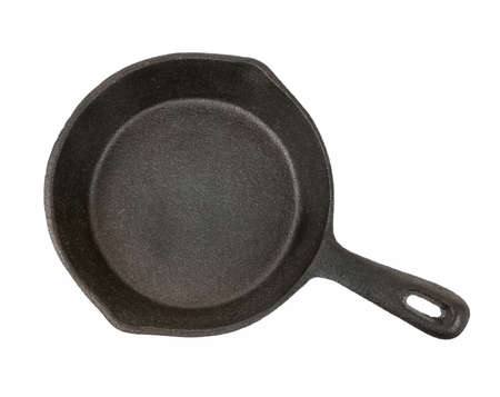 Cast iron black frying pan isolated on white background, from aboveの写真素材
